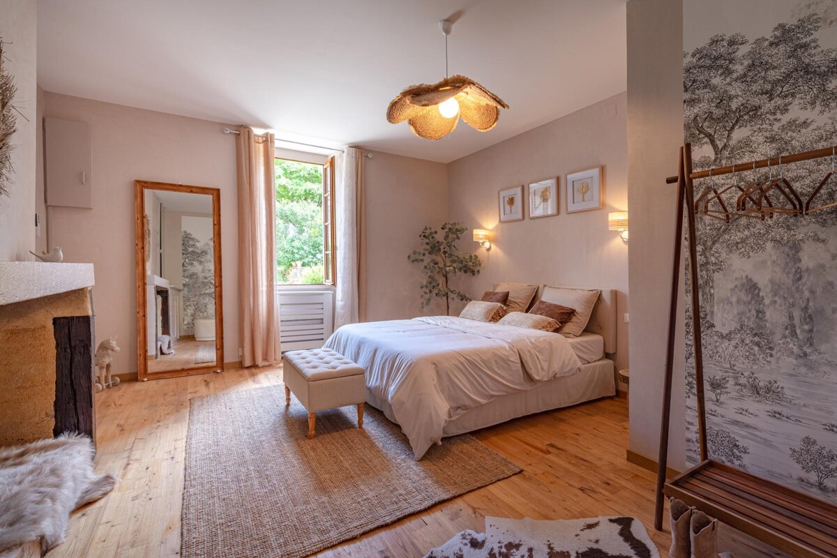 A bedroom with a large bed and a mirror