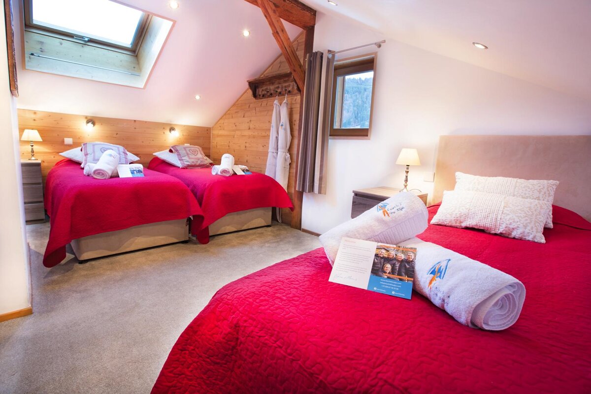A hotel room with two beds and a book on the bed