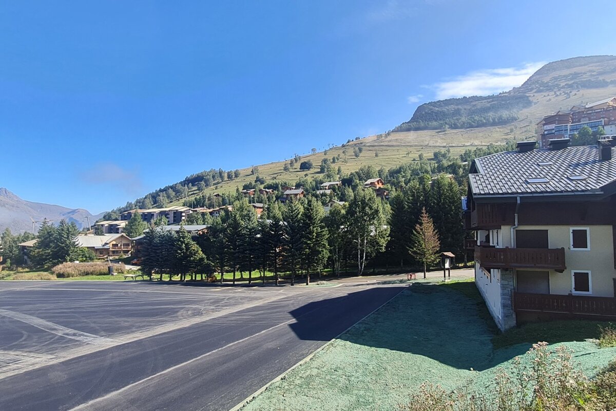An empty parking lot with a mountain in the background