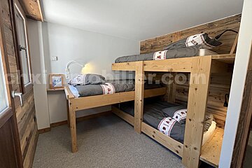 A bedroom with bunk beds and a sign that says mobilier.com