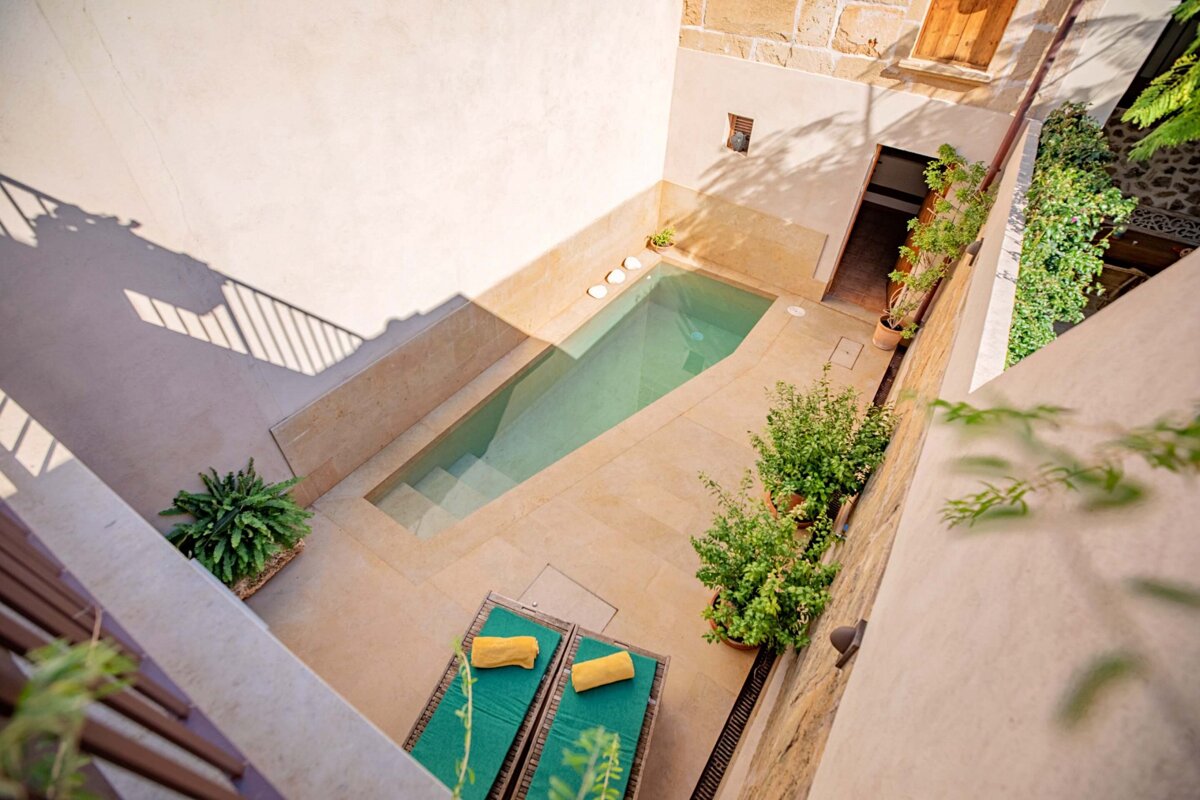 An aerial view of a swimming pool in a courtyard
