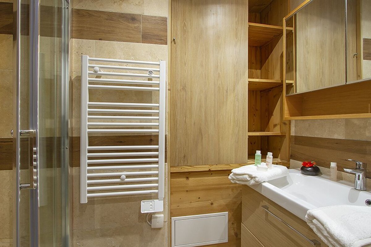 A bathroom with a towel rack and a sink