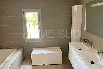 A bathroom with two sinks and a window that says home sud