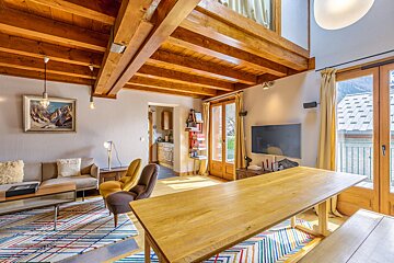 A living room with a wooden table and chairs