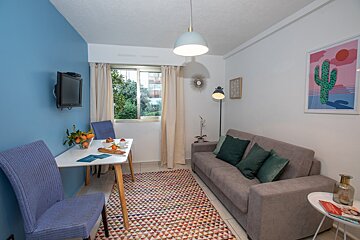 A living room with a couch a table and chairs