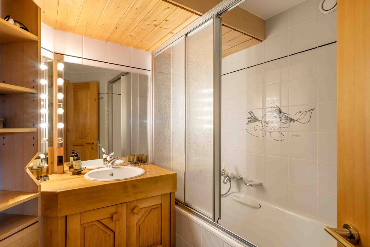 A bathroom with a sink a mirror and a bathtub