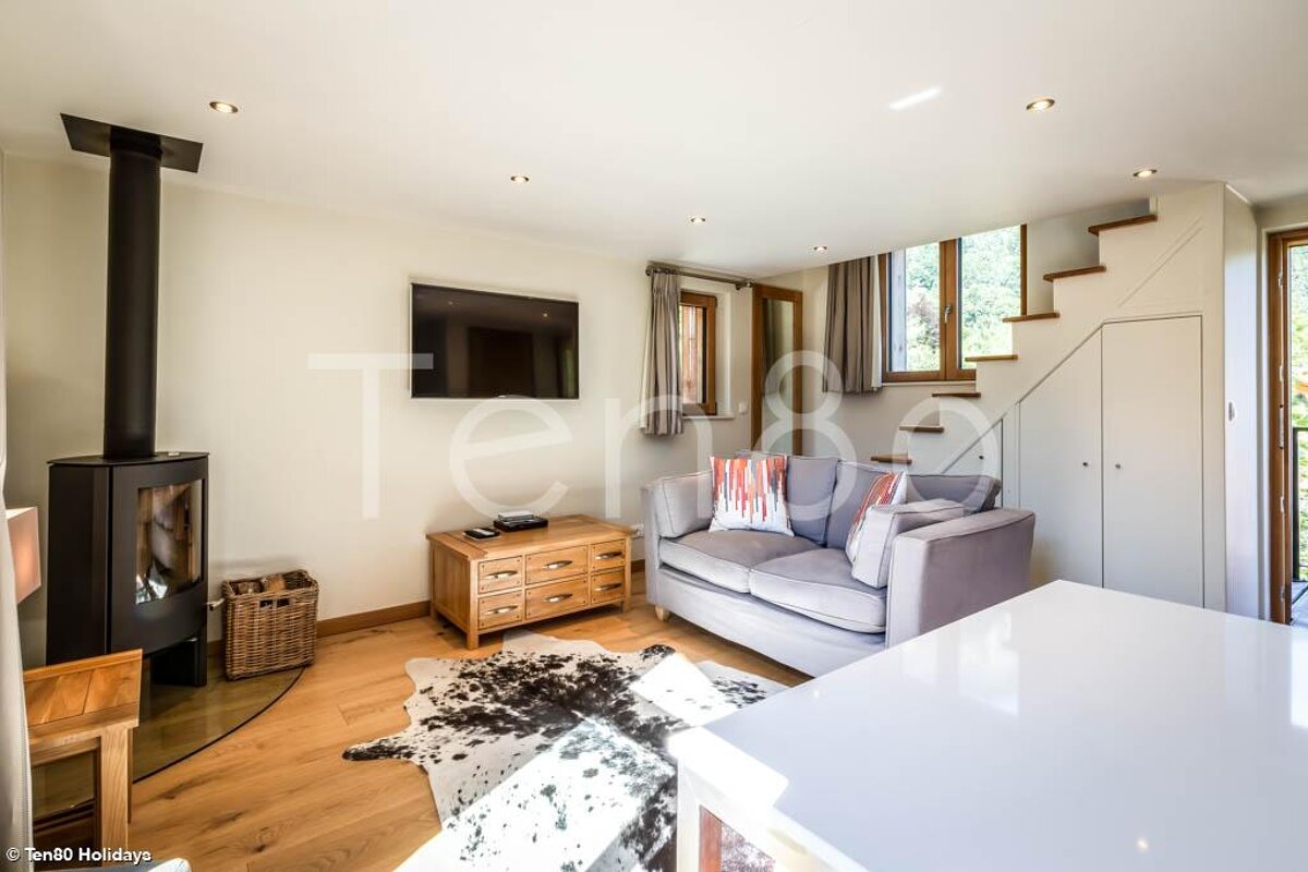 A living room with a couch and a flat screen tv