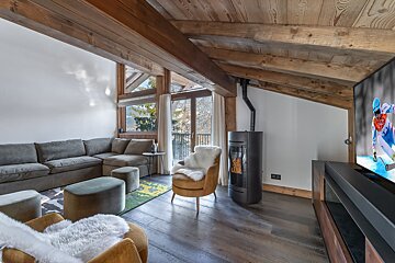 A living room with a sectional couch and a chair