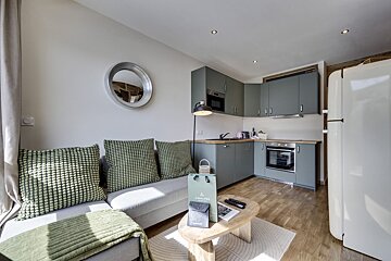 A living room with a couch and a bag that says orchard on it