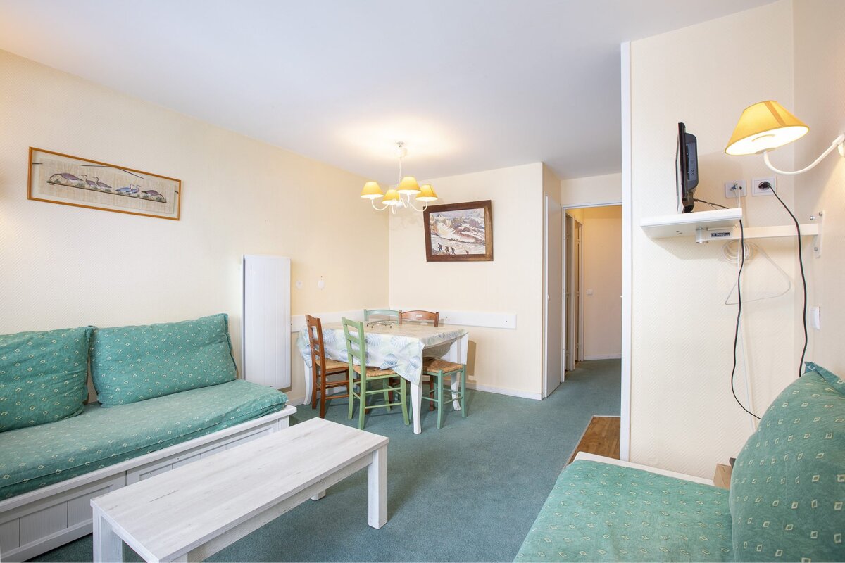 A living room with a couch a table and chairs