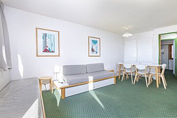 A living room with a couch a table and chairs