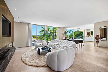 A living room with a couch and two chairs