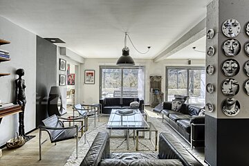 A living room with a couch and chairs with faces on them