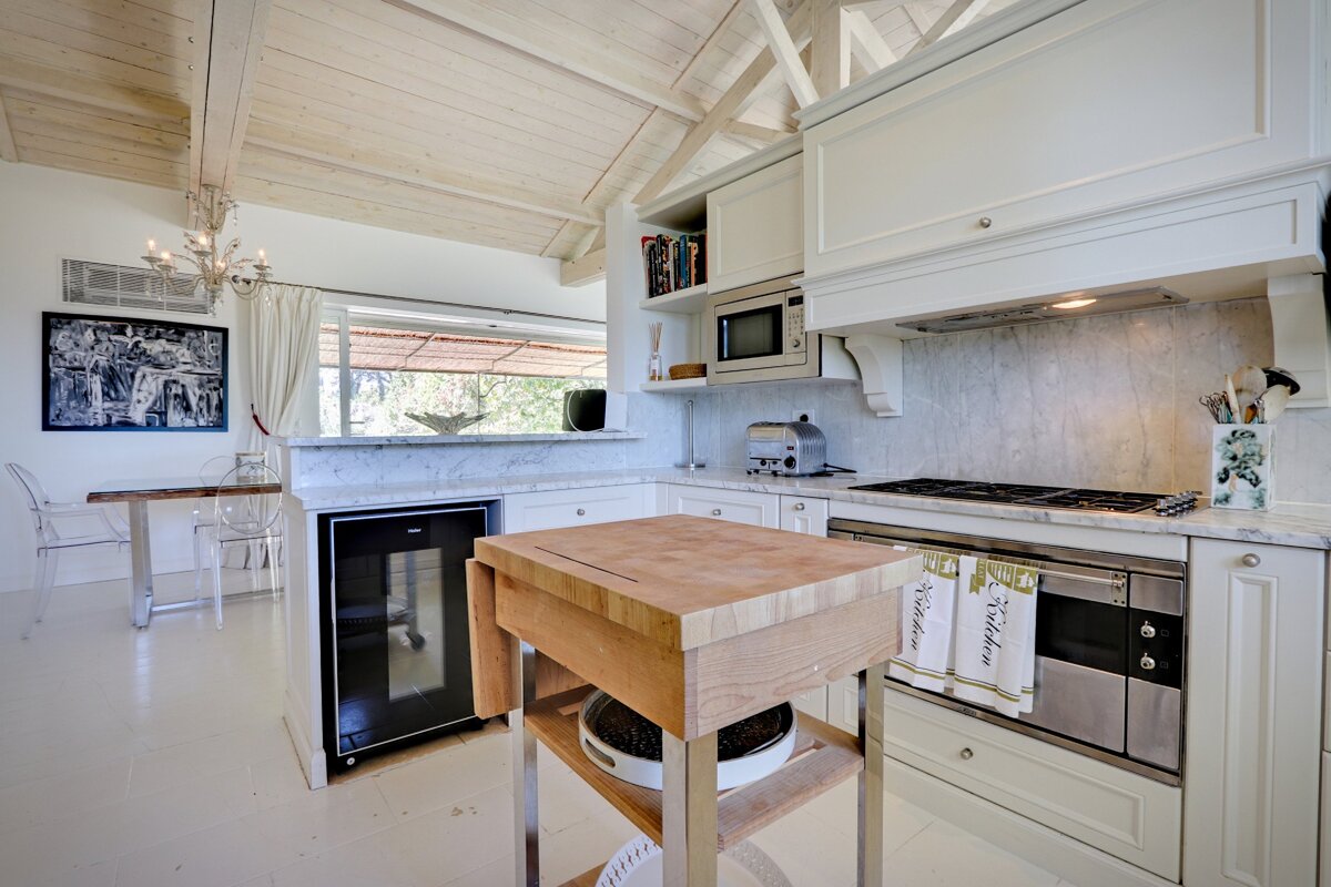 A kitchen with stainless steel appliances and white cabinets