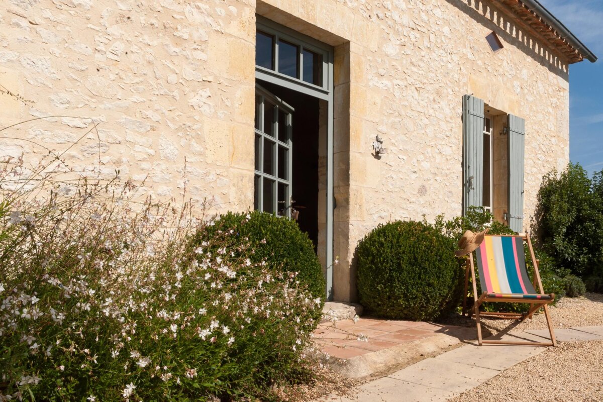 A striped chair sits in front of a stone building