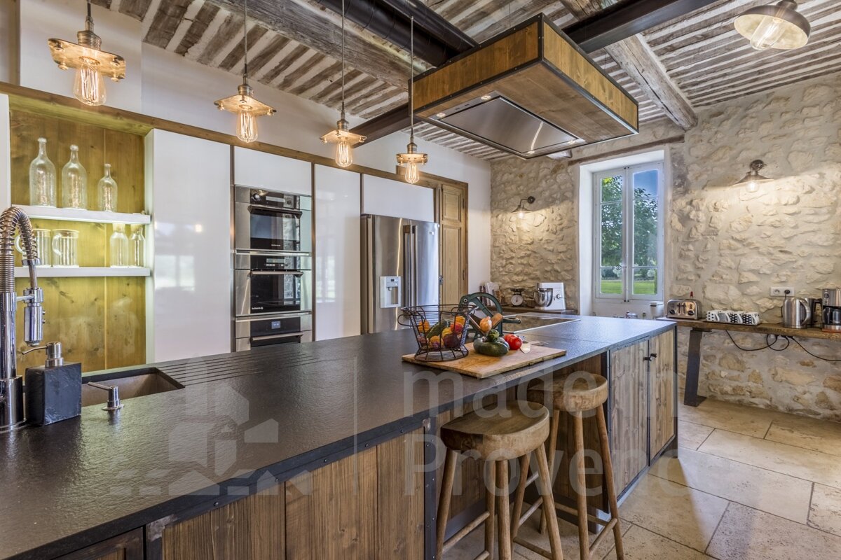 A kitchen with a large island and a sign that says image prive