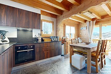 A kitchen with a table and chairs and the word alpine on the bottom