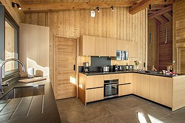 A kitchen with wooden cabinets and stainless steel appliances