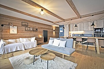 A living room with a couch and two coffee tables