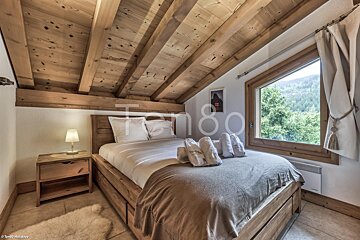 A bedroom with a bed and a window with the number 80 on it