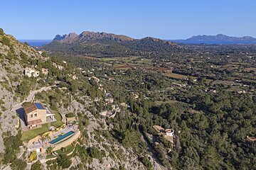 An aerial view of a valley with mountains in the background