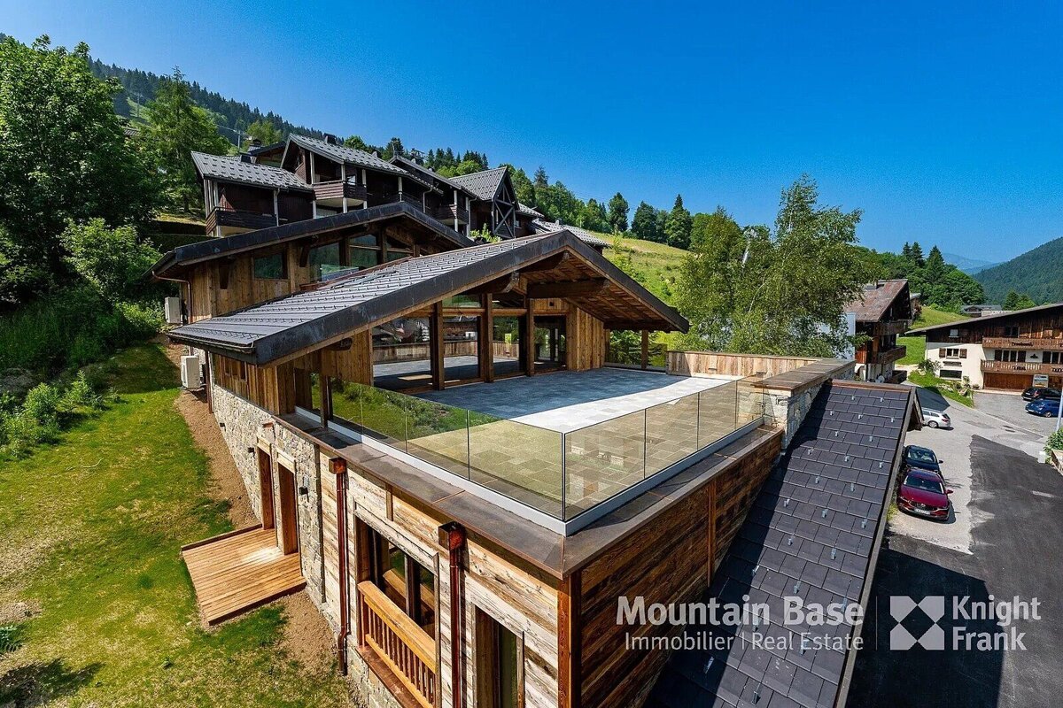 A large house with a balcony is for sale by mountain base