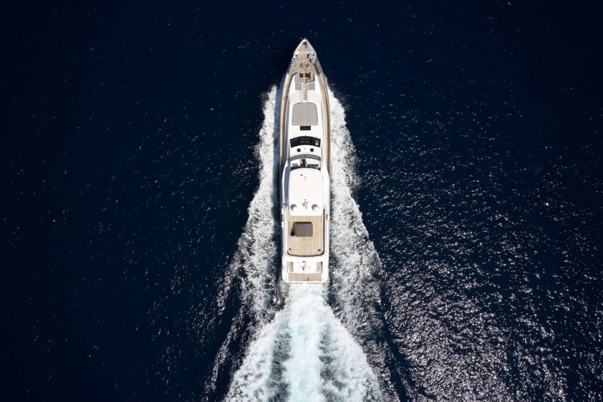 A large white yacht is floating in the ocean