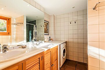 A bathroom with a sink and a washer and dryer