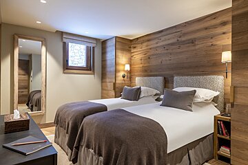 A hotel room with two beds and a mirror