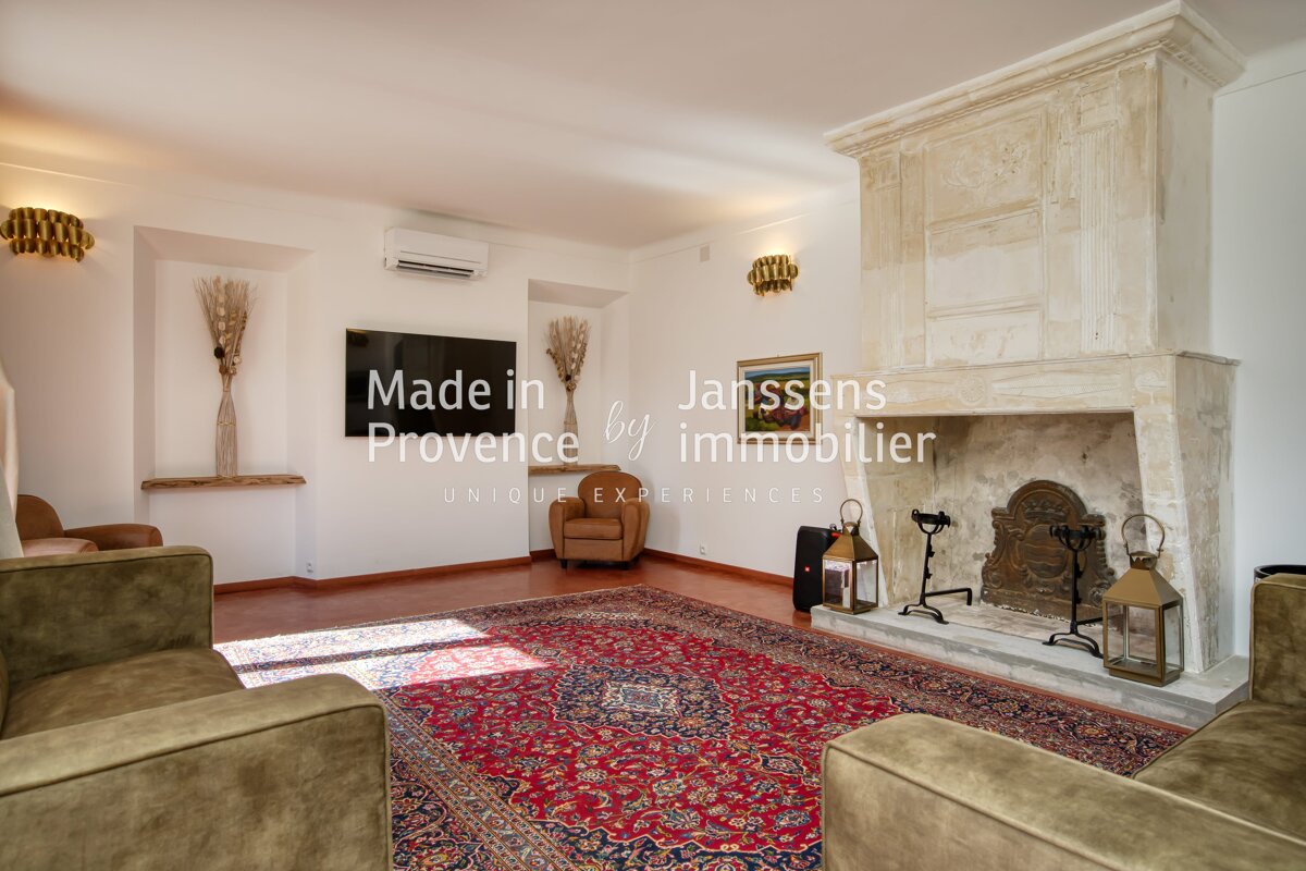 A living room with a fireplace made in provence by immobilier