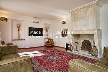 A living room with a fireplace made in provence by immobilier