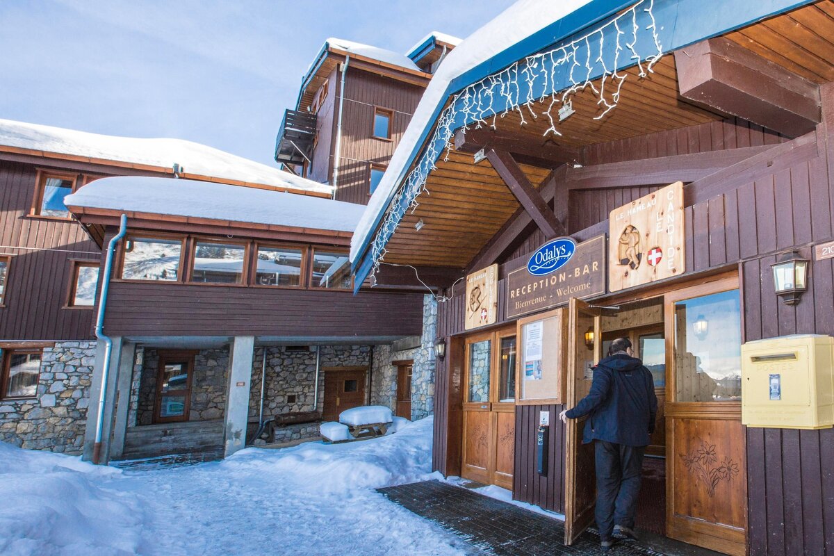 A man entering a building with a sign that says reception bar