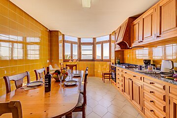 A bottle of wine sits on a table in a kitchen