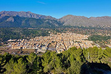An aerial view of a city with mountains in the background