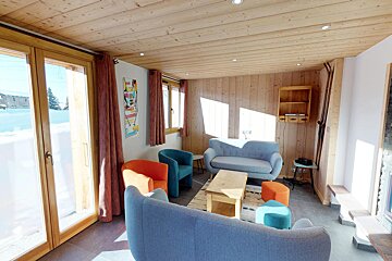 A living room with a couch and two chairs