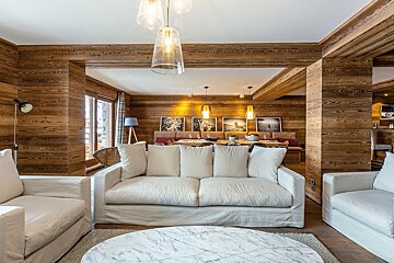 A living room with a couch and two chairs