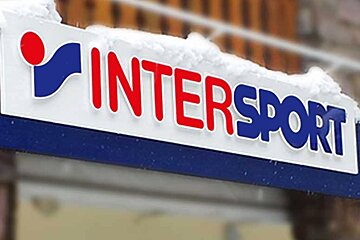 A sign for intersport is covered in snow