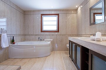 A bathroom with a toilet a sink and a shower