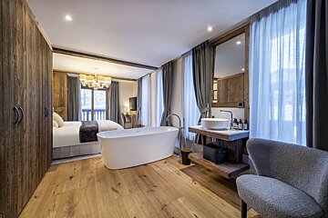 A hotel room with a bathtub and a sink