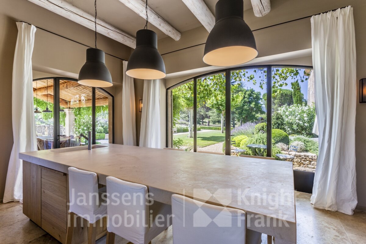 A dining room with a large island and a sign that says janssens immobilier
