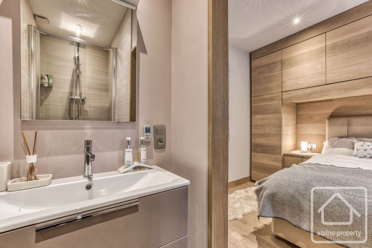 A bathroom with a sink and a mirror and a sign that says alpine property