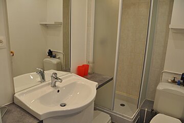 A bathroom with a sink a toilet and a shower