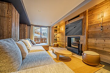 A living room with a fireplace and a flat screen tv