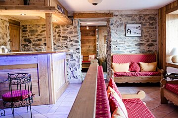 A room with a couch and a picture on the wall