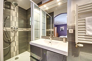 A bathroom with a picture of a deer on the wall