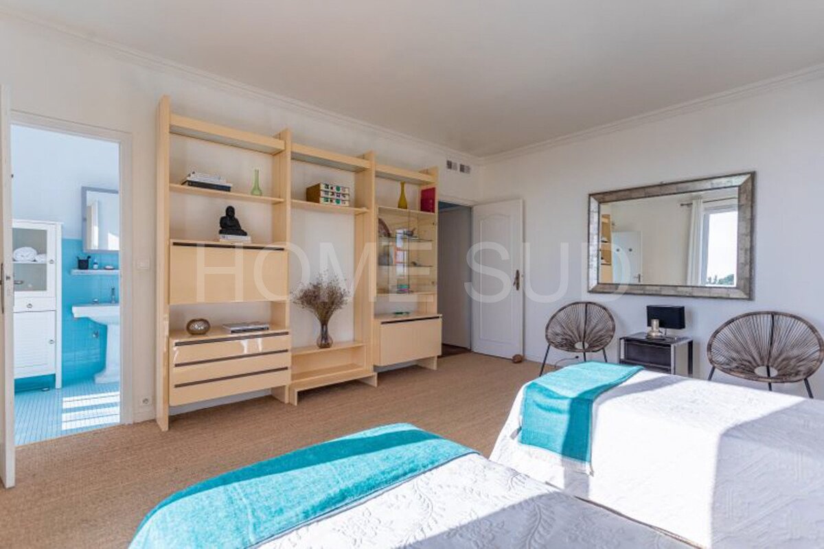 A bedroom with two beds and a shelf that says home su