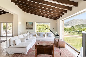 A living room with a large couch and a chair