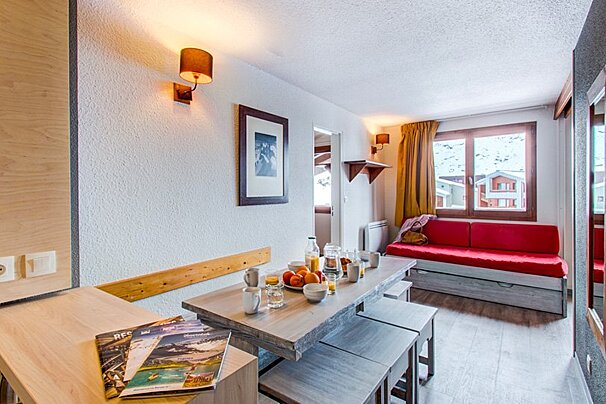 A living room with a table and chairs and a magazine that says rfp on it