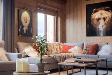 A living room with a couch and a painting of a bear on the wall