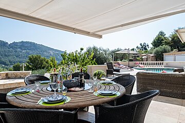 A table with plates and a bottle of wine on it